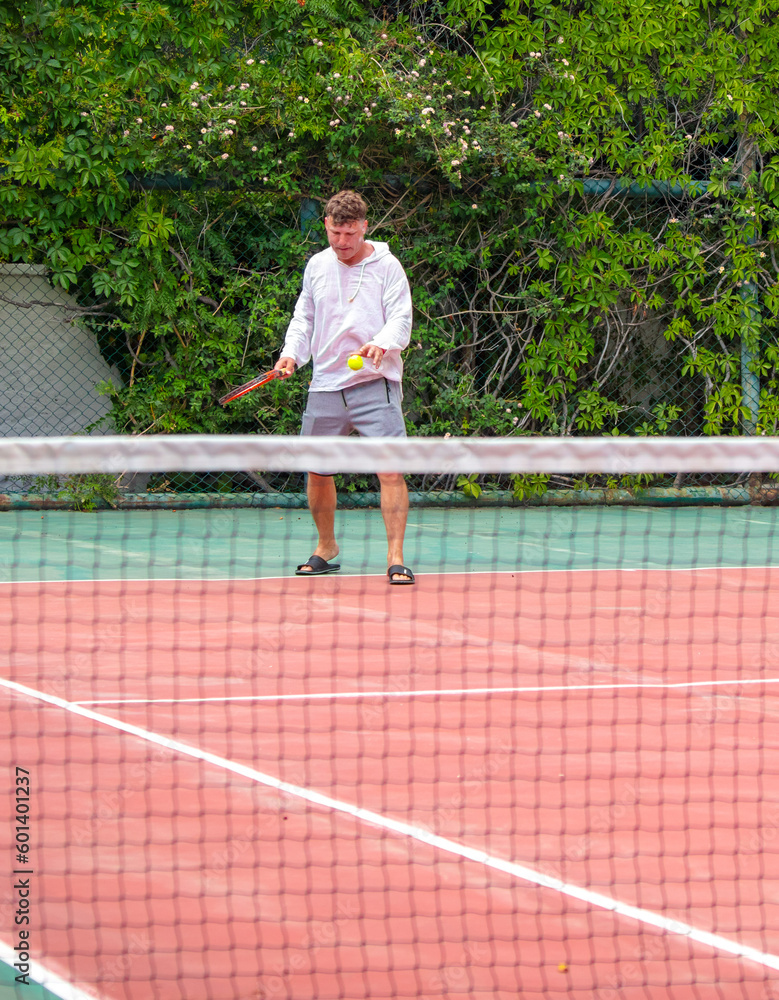 A man plays tennis on the court.
