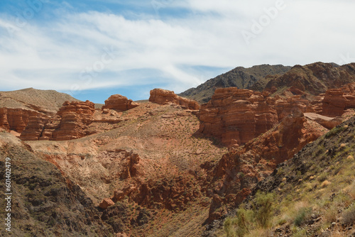 Charyn Canyon is a canyon on the Sharyn River in Kazakhstan east of Almaty. Landscape on a clear sunny day in summer, there are many clouds in the sky. 