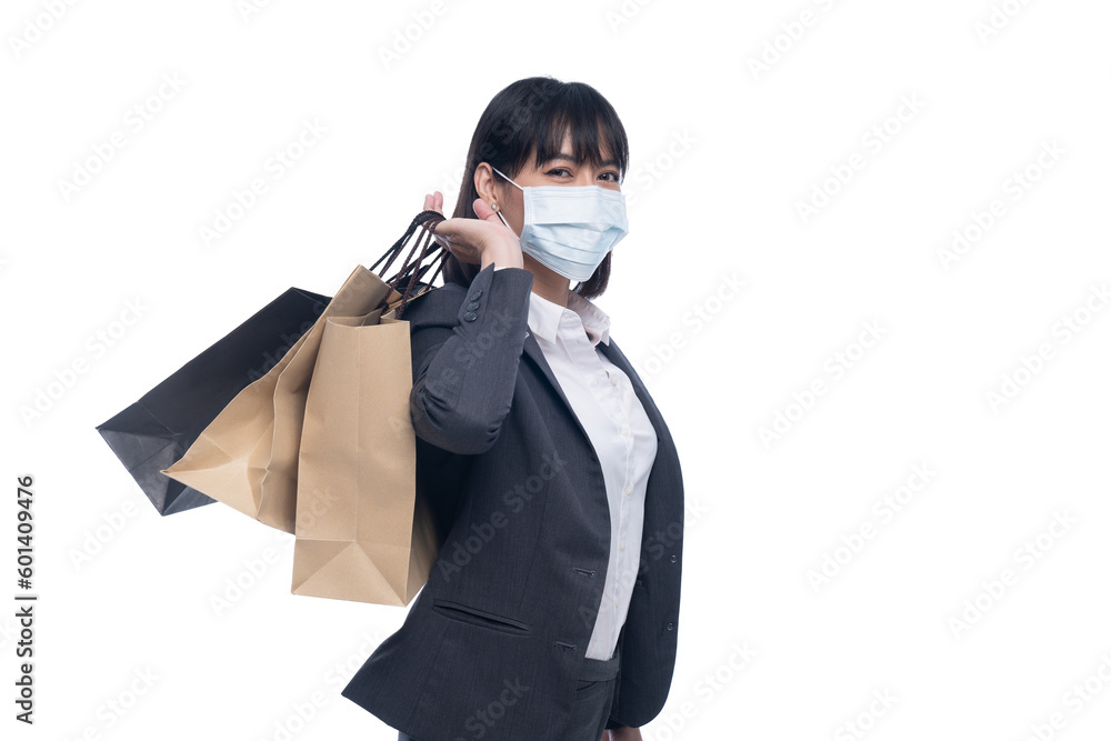 Woman in work clothes holding shopping bags.
