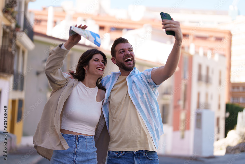Portrait of a young couple enjoying their fun vacation and taking a selfie