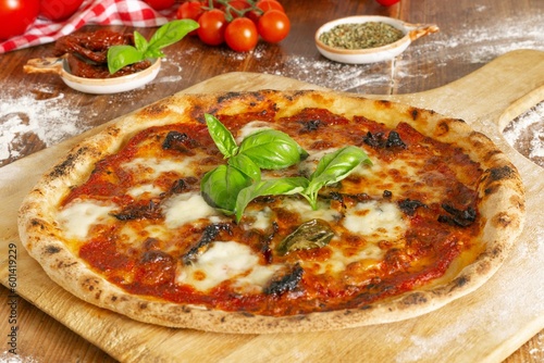 Fresh Homemade Italian Pizza Margherita with dried tomatoes, buffalo mozzarella and basil