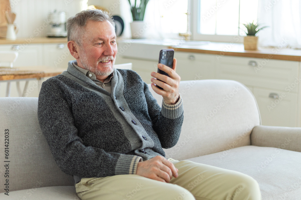 Happy middle aged senior man talk on video call with friends family. Laughing mature old senior grandfather having fun speaking with grown up children online. Older generation modern tech usage Happy middle aged senior man talk on video call with friends family. Laughing mature old senior grandfather having fun speaking with grown up children online. Older generation modern tech usage