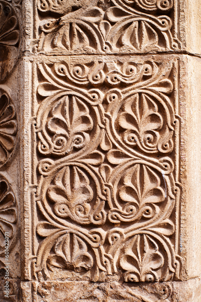 Floral bas-relief on the facade of an ancient temple in Georgia. Architectural decorative element, background
