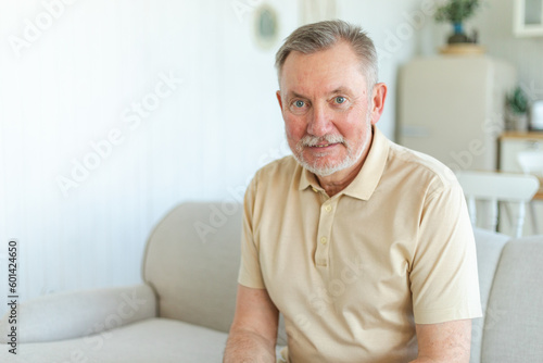 Confident stylish middle aged senior man at home. Older mature 70s man smiling. Happy attractive senior beard grandfather looking camera close up face headshot portrait. Happy people