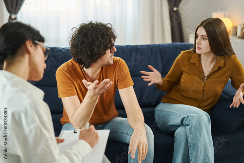 Marital Psychotherapy. Man and woman having conflict and quarrel during therapy session. Marital crisis  marriage counseling concept