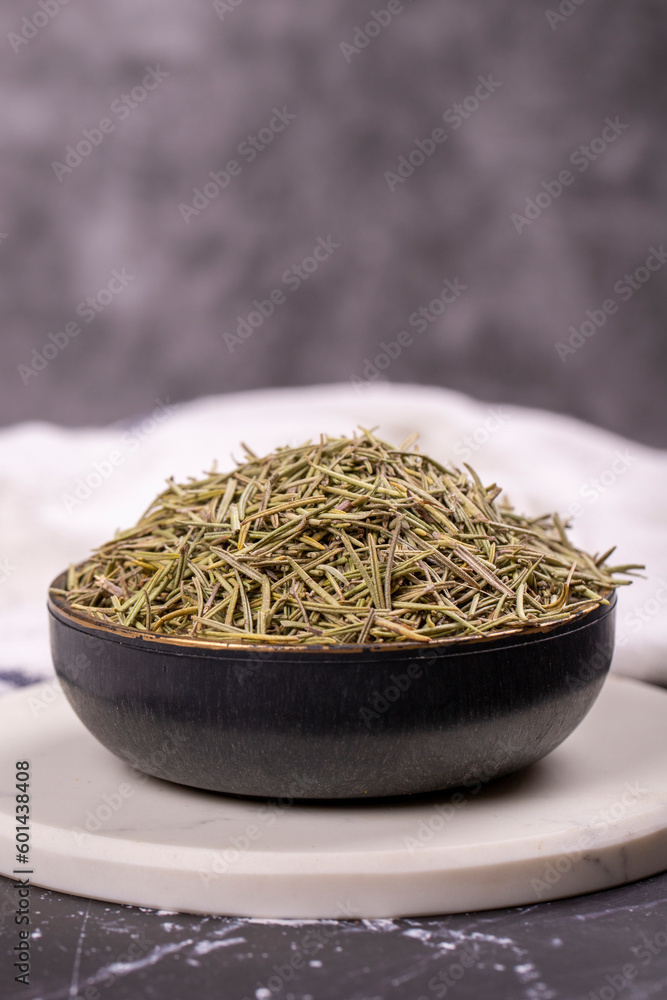 Dried herbs rosemary leaf. Dry seasoning rosemary on dark background. Spices and herbs for cooking, provence herbs. Close up