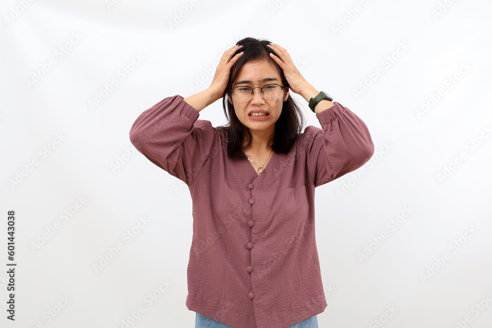 Stressed young asian woman standing while holding her head. Isolated on white background Stressed young asian woman standing while holding her head. Isolated on white background