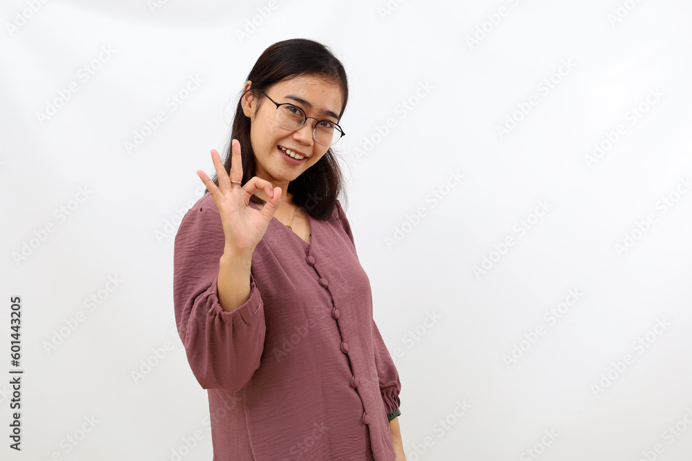Asian young woman showing okay hand gesture. Isolated on white Asian young woman showing okay hand gesture. Isolated on white