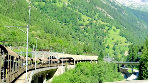 car transport vehicles driving along Lötschberg railway tunnel, old train with cars and passengers, transportation transport in Switzerland from Kandersteg to Goppenstein, concept travel in mountains photo