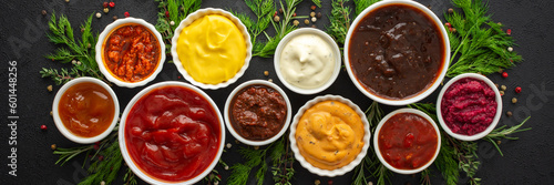 Different types of sauces in bowls with seasonings banner, rosemary and dill, thyme and and peppercorns, top view, copy space