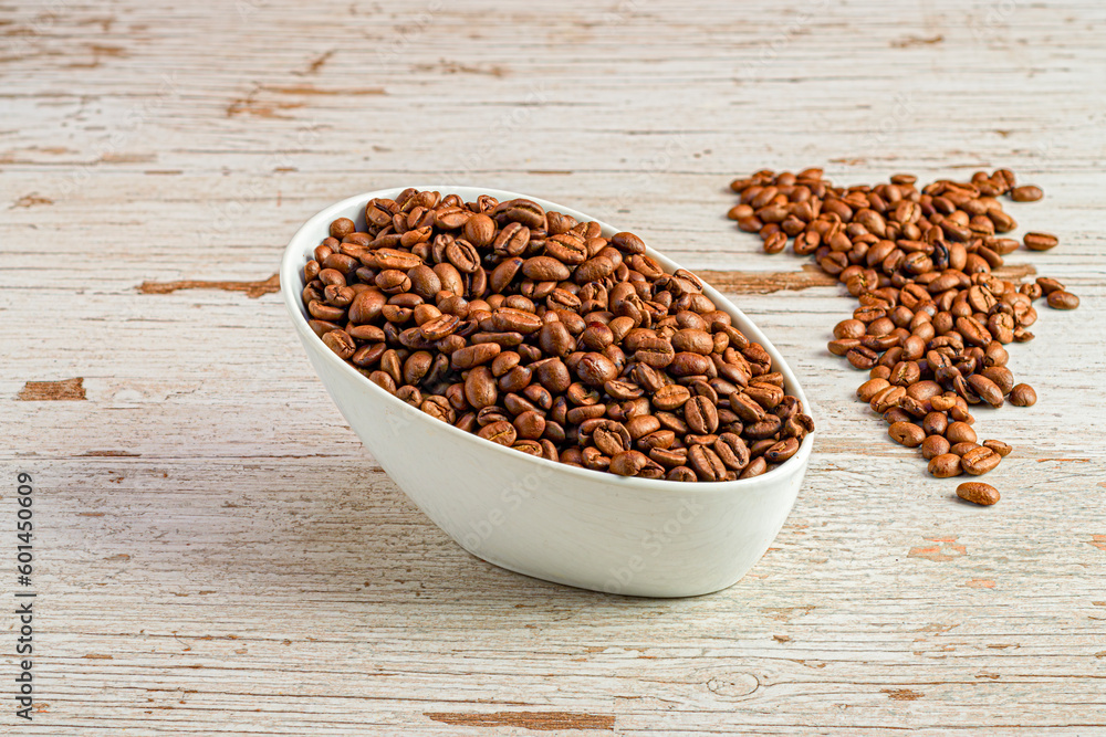 The Art of Coffee: Roasted Coffee Beans and a Full Cup on a Rustic Wooden Table The Art of Coffee: Roasted Coffee Beans and a Full Cup on a Rustic Wooden Table