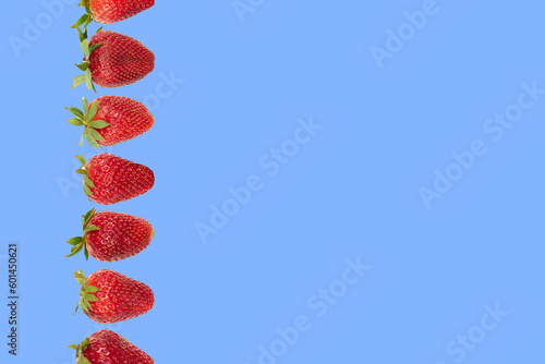composition whith strawberries on a blue background
