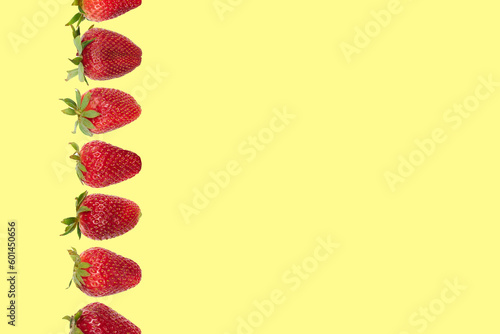composition whith strawberries on a vanilla yellow background