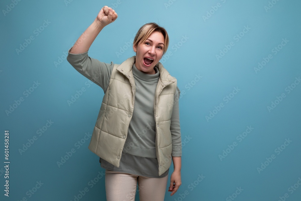 positive woman young with blond hair is inspired by an idea on a blue background with copy space positive woman young with blond hair is inspired by an idea on a blue background with copy space