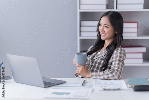 young asian businesswoman working on laptop computer in her workstation. Portrait of Businesspeople employee freelance online marketing e-commerce telemarketing concept.