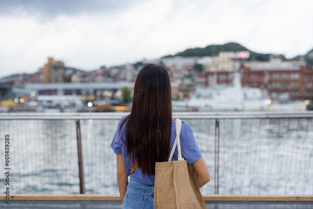 Tourist woman look at the sea in Keelung of Taiwan