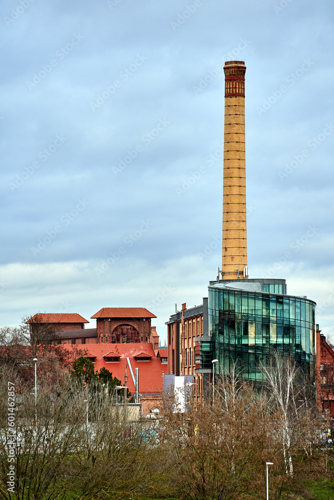 Obraz premium Buildings and brick chimney of a former gasworks in the city of Poznan