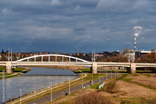 Steel structure of the bridge over the Warta River and smoke from an industrial chimney in Poznan