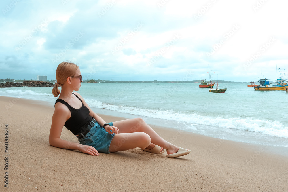 Travel. Travelers woman on the coast of the ocean on a tropical island. Solitude, wildlife, mental health, conscious travel, travel and active life concept. Travel banner Travel. Travelers woman on the coast of the ocean on a tropical island. Solitude, wildlife, mental health, conscious travel, travel and active life concept. Travel banner