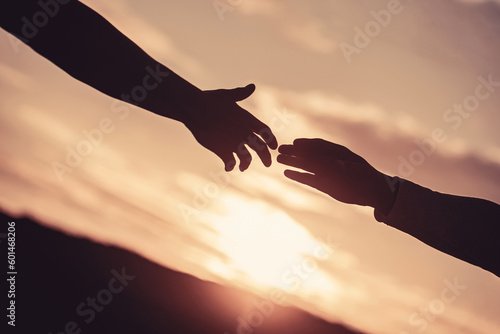Rescue, helping gesture or hands. Outstretched hands, salvation, help silhouette, concept help. Two hands silhouette on sky background, connection or help concept