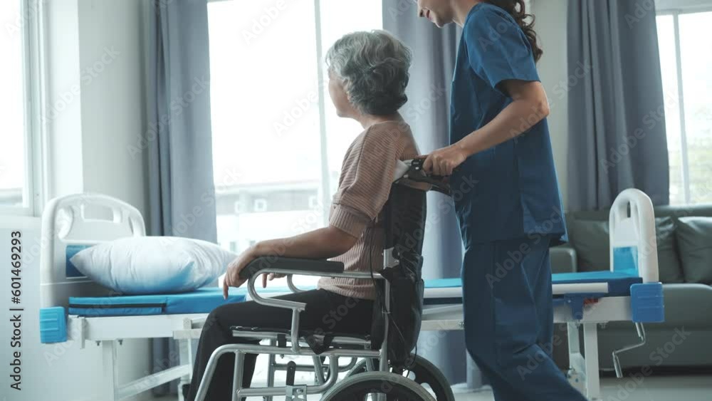 Asian senior care nurses and grandmothers provide caring support to elderly women hand clasp to encourage exercising with elder disabled person patient with caregiver in nursing care.