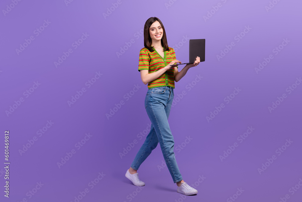 Full length photo of shiny pretty woman dressed striped cardigan texting modern device isolated violet color background Full length photo of shiny pretty woman dressed striped cardigan texting modern device isolated violet color background