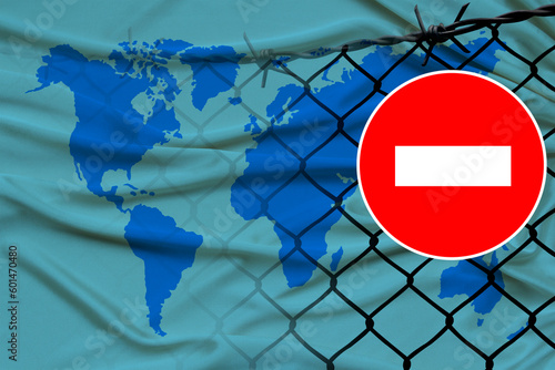 world map on satin, fence with barbed wire, symbolic red sign no entry, entry is prohibited, travel restrictions across European Union border, emigration problems, concept tourism, economics, politics