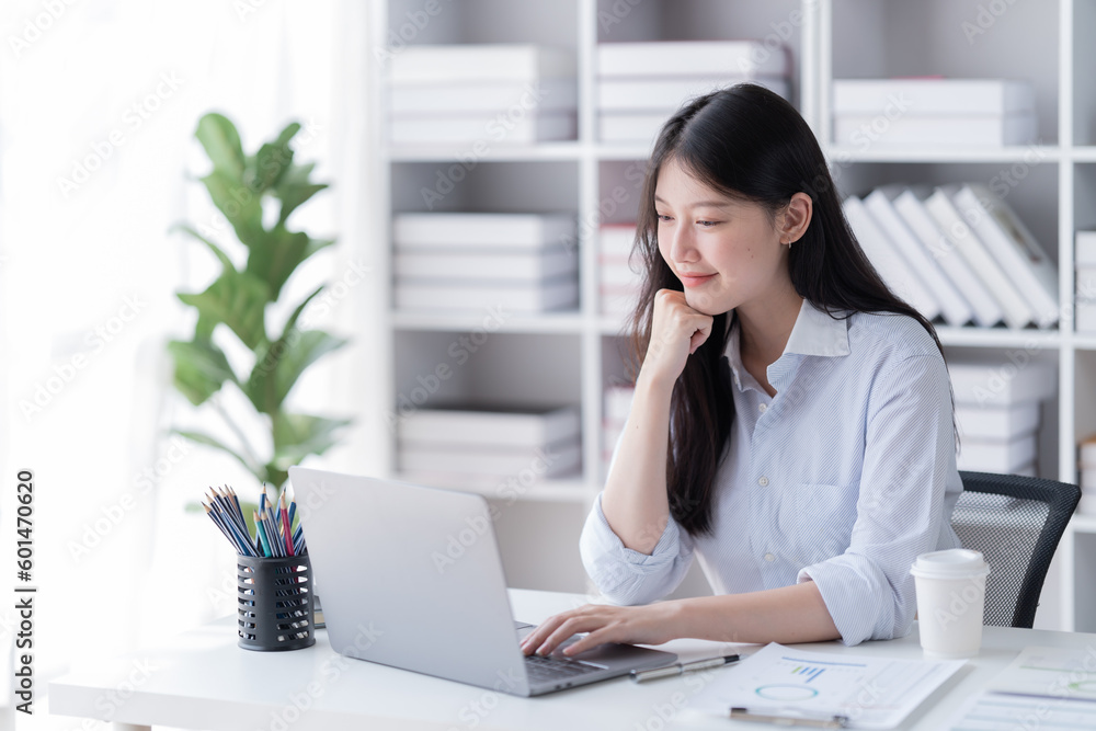 Smiling of business women holding coffee cup working in the office. Smiling of business women holding coffee cup working in the office.