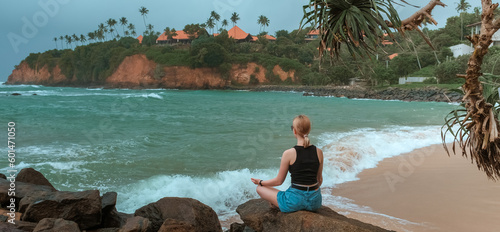 Travel. Travelers woman on the coast of the ocean on a tropical island. Solitude, wildlife, mental health, conscious travel, travel and active life concept. Travel banner photo