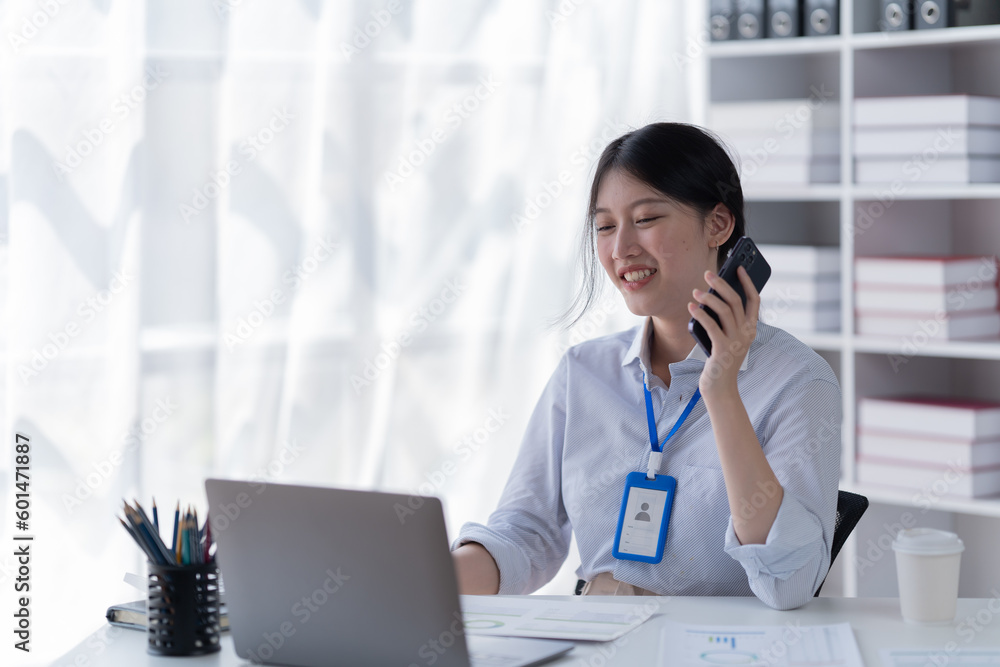 Smiling of business women holding coffee cup working in the office. Smiling of business women holding coffee cup working in the office.