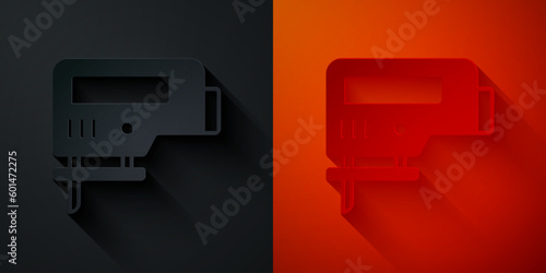 Paper cut Electric jigsaw with steel sharp blade icon isolated on black and red background. Power tool for woodwork. Paper art style. Vector