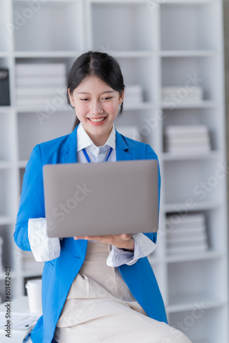 Young Asian woman working with a laptop and smartphone. Freelancer Businesswoman at work.