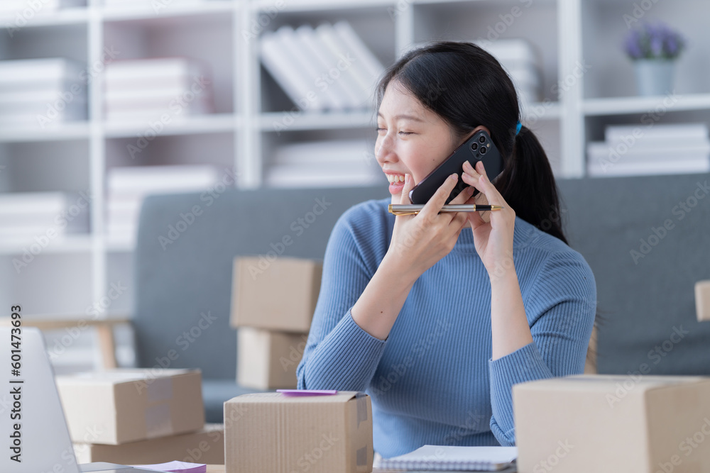 Startup SME small business entrepreneur of freelance Asian woman using a laptop with box Cheerful success Asian woman her hand lifts up online marketing packaging box and delivery SME Startup SME small business entrepreneur of freelance Asian woman using a laptop with box Cheerful success Asian woman her hand lifts up online marketing packaging box and delivery SME