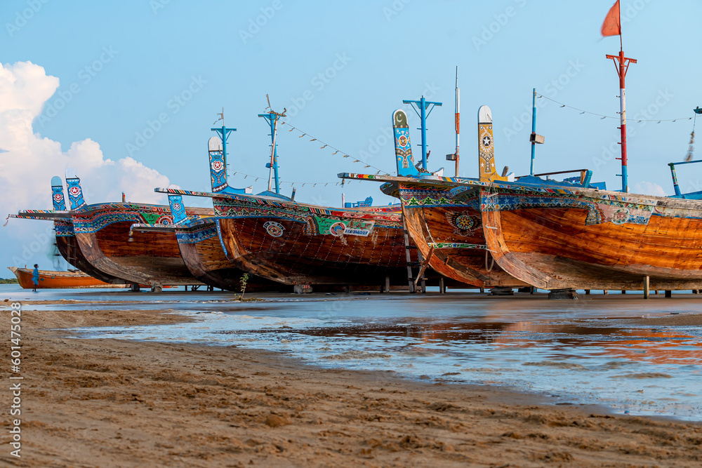 Fototapeta premium Sunset view with cloudy sky at Gadani Beach with dhow boat