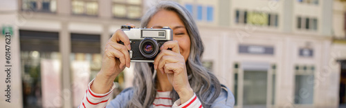 Woman photographer taking photo at city center