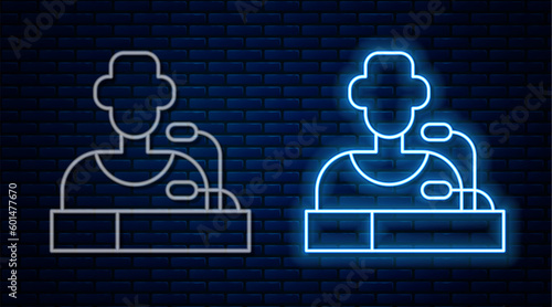 Glowing neon line Football player press conference icon isolated on brick wall background. Vector