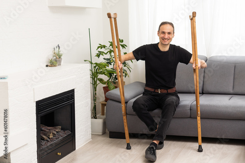 фотографія Young man with axillary crutches