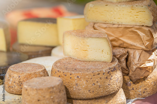 Hard cheeses. A large piece of cheese in a cheese factory, on a shelf. Production and sale of cheese. Small business concept.