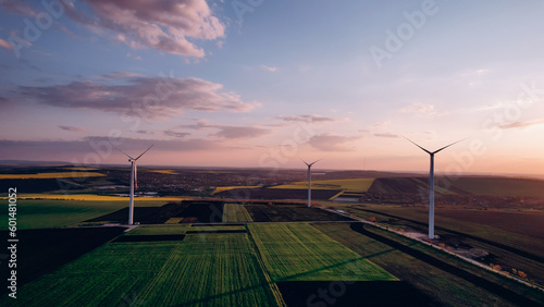 Windmill turbines generating green energy electric.Green energy helps reduce carbon emissions and makes earth cleaner and more ecological.