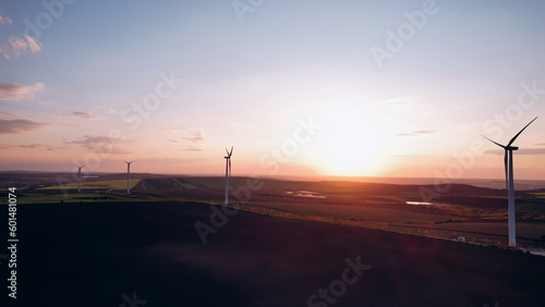 Windmill turbines generating green energy electric.Green energy helps reduce carbon emissions and makes earth cleaner and more ecological.