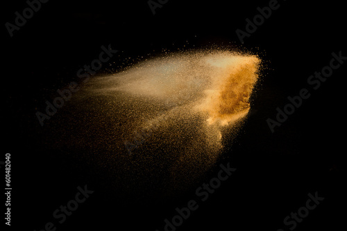 Dry river sand explosion isolated on black background. Abstract sand cloud.Brown colored sand splash against dark background.