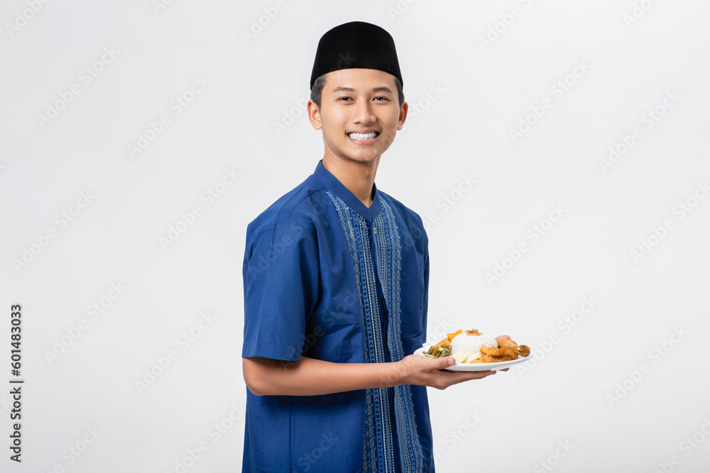 Young muslim man volunteer holding and sharing food for other person isolated on white background. Concept of alms, food sharing and help each other. Young muslim man volunteer holding and sharing food for other person isolated on white background. Concept of alms, food sharing and help each other.