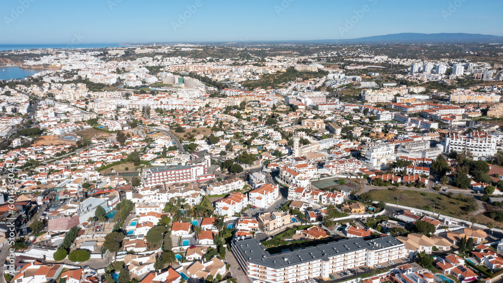 Aerial photo of the beautiful town in Albufeira in Portugal showing the pretty town on a hot summers day with blue skies on a hot summers day in the summer time.