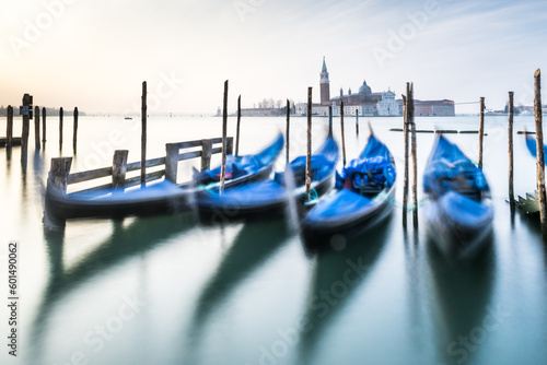 Blue gondolas in Venice in slow pose.  Italy © Jean Isard