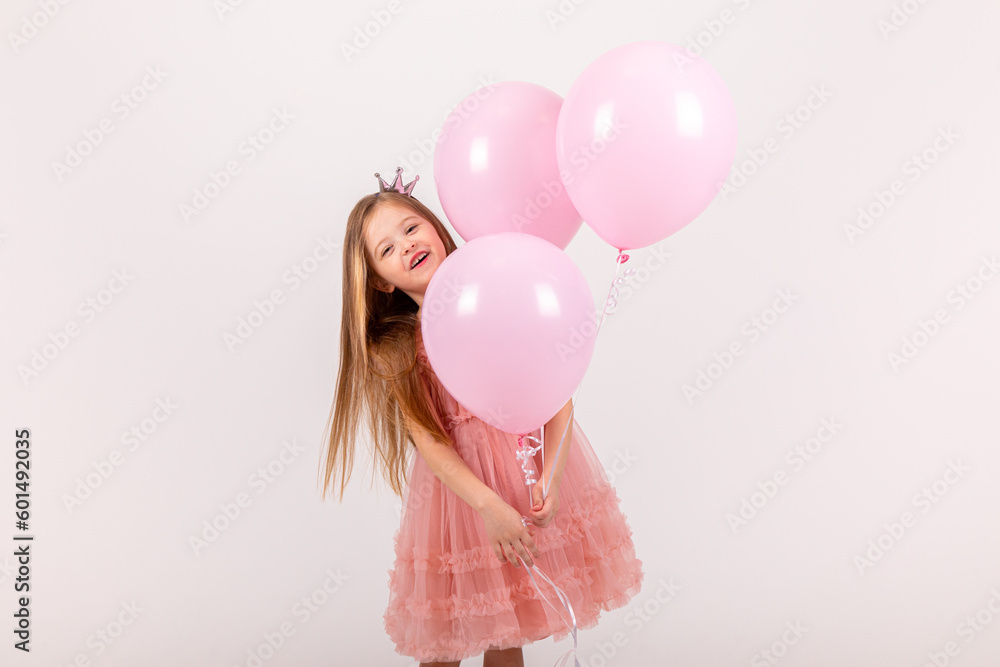 Cute smiling little girl in a pink princess dress posing with air ...