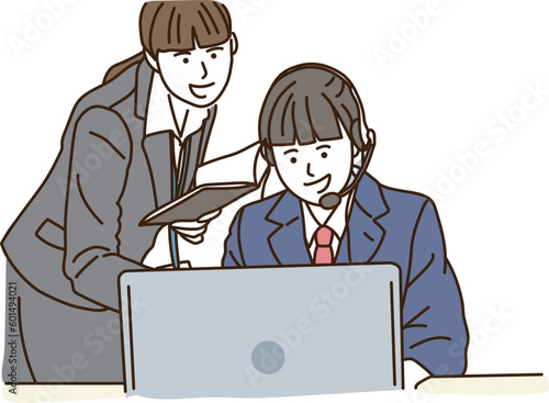パソコン操作をする女子学生と教える先生