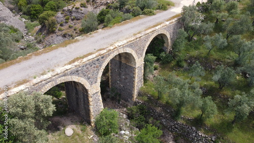 Tatar Bridge - Very old stone arch bridge from Ottoman or even older times about 30 m long with three arches, 2 central piers, completely preserved near Urla, Turkish Aegean Sea