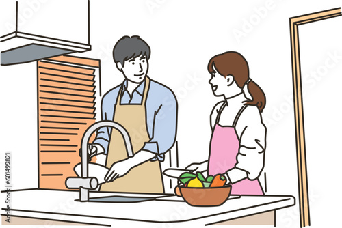 キッチンで料理をする若い男女
