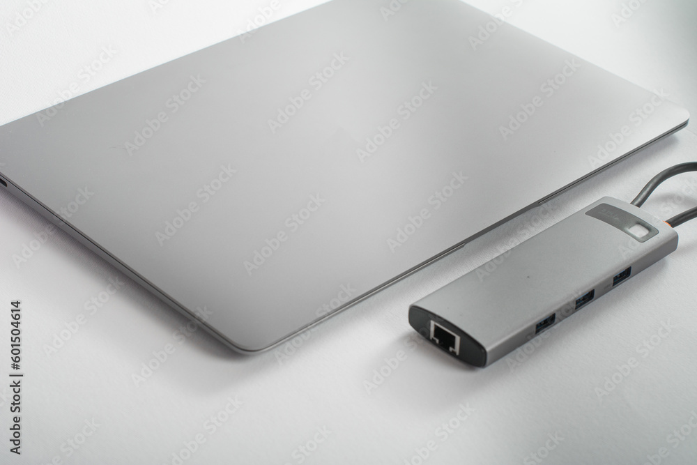 The USB adapter is connected to a laptop with various inputs for a flash drive, hdmi, ethernet, memory card, cables. The USB adapter is connected to a laptop with various inputs for a flash drive, hdmi, ethernet, memory card, cables.