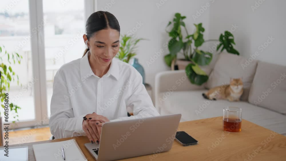 Friendly businesswoman greeting computer at remote office. Woman studying online Friendly businesswoman greeting computer at remote office. Woman studying online